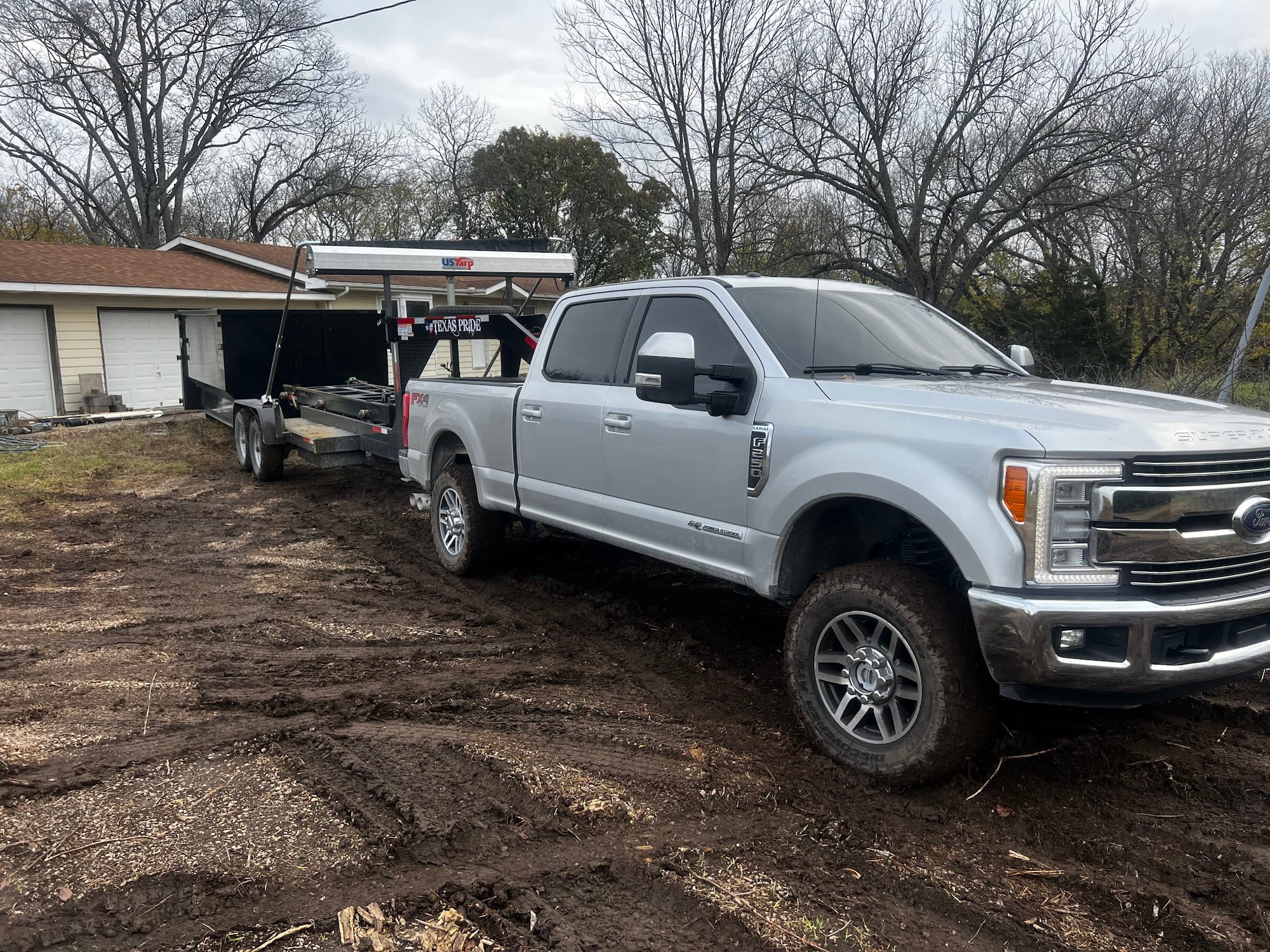Elite truck and dumpster trailer at a job site