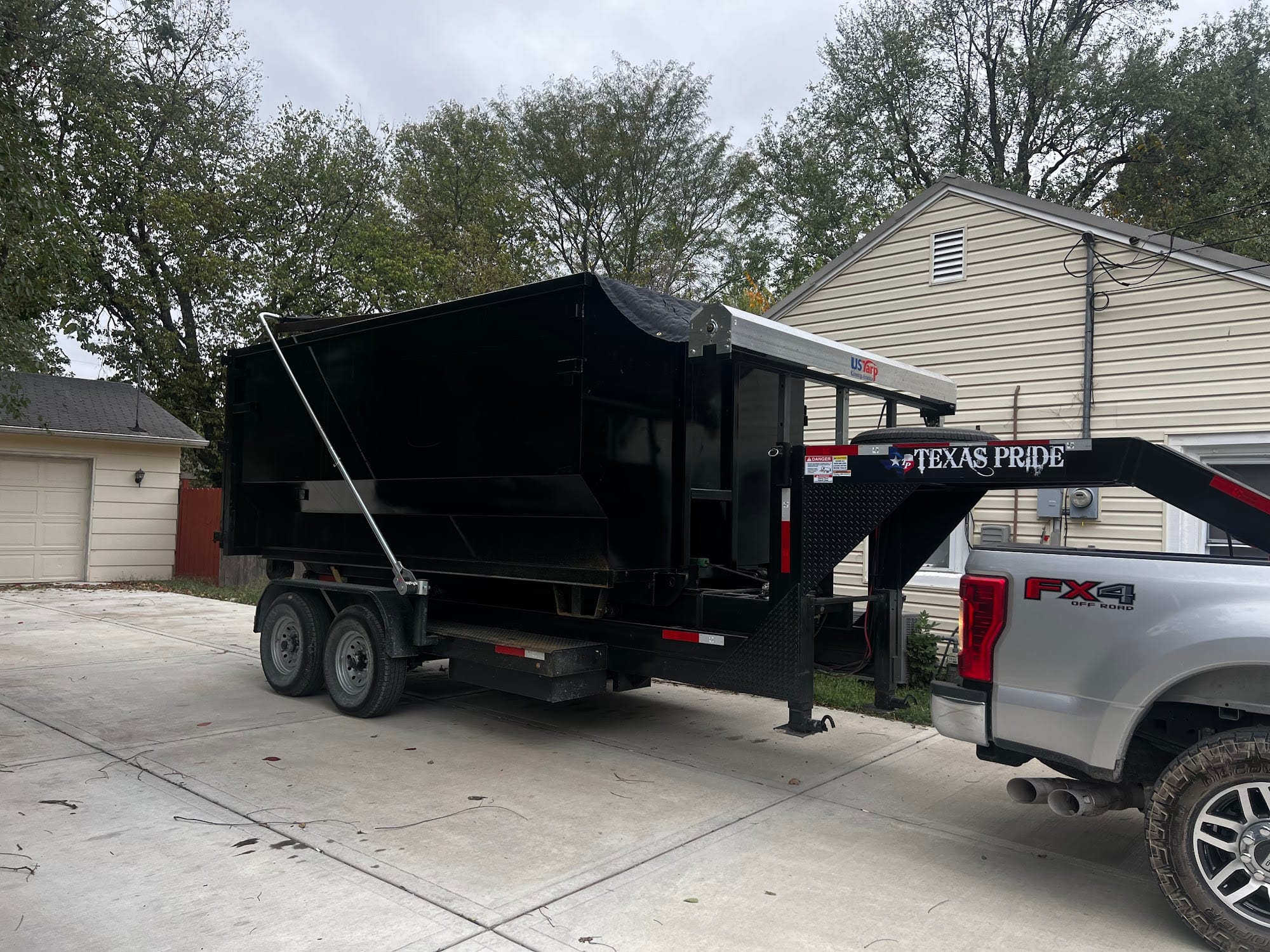 Unloading a full dumpster at the dump