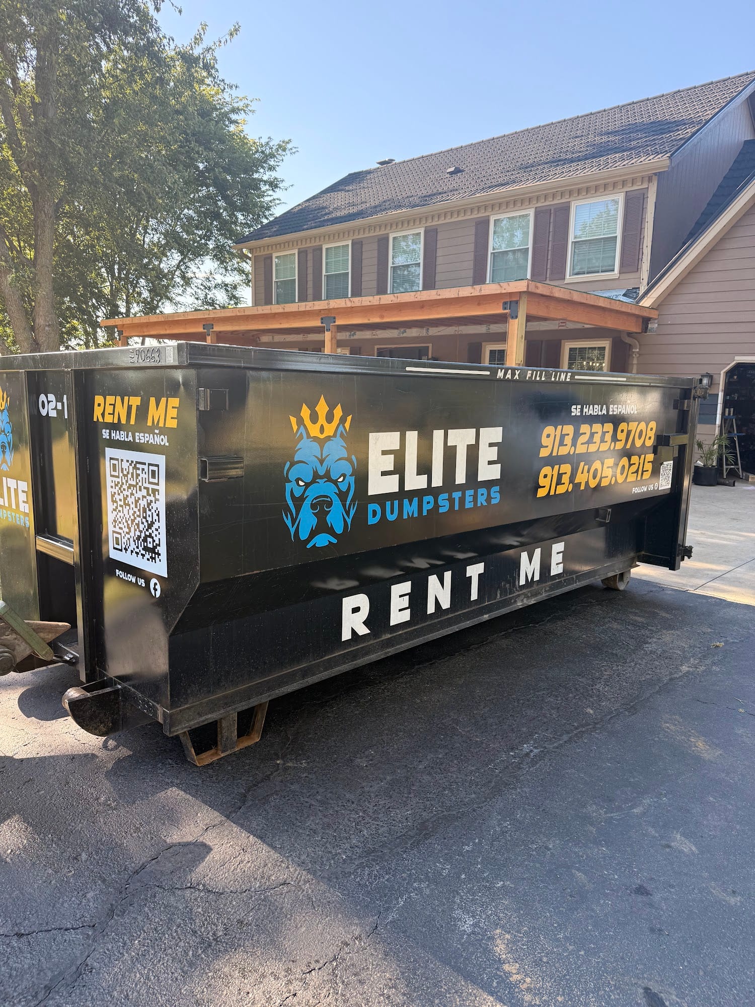 Elite Dumpsters roll-off dumpster in a home driveway